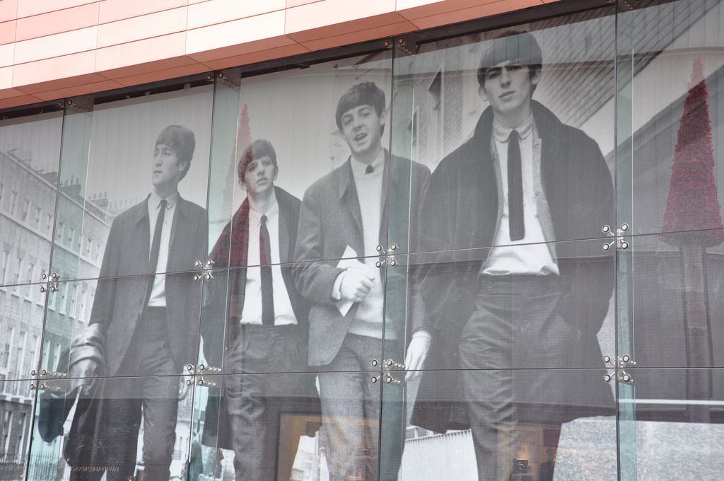 Super large photo of the fab four on the window of a large shop in Liverpool.