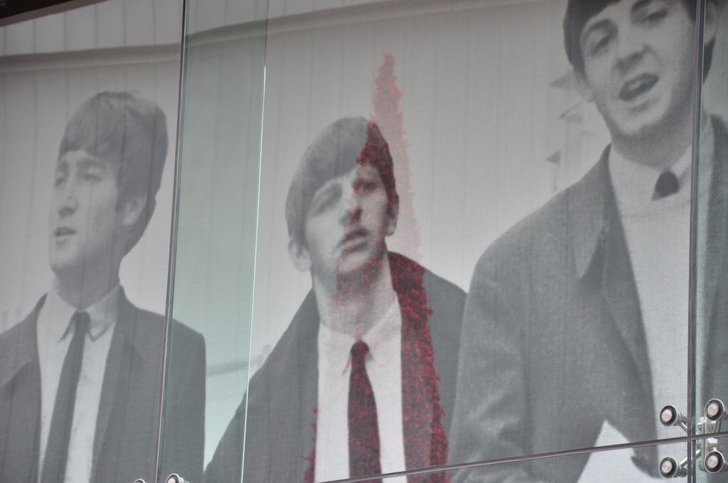 Super large photo of the fab four on the window of a large shop in Liverpool.